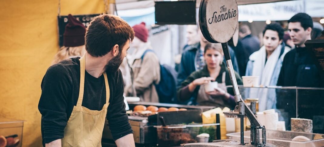 a busy business owner looking back at long queue