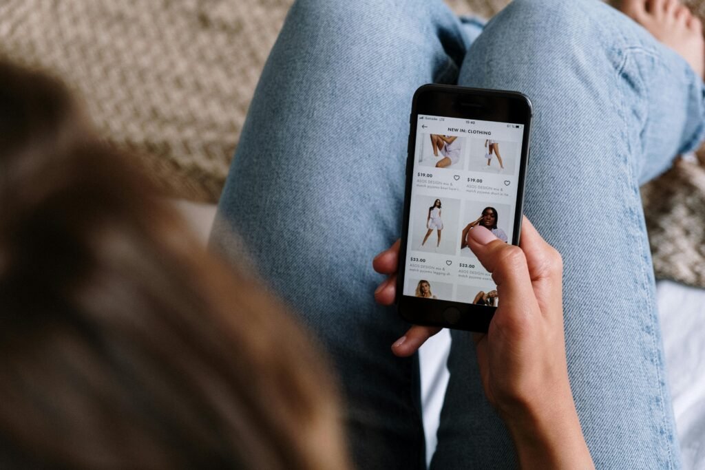 a woman scrolling through her phone browsing for outfit