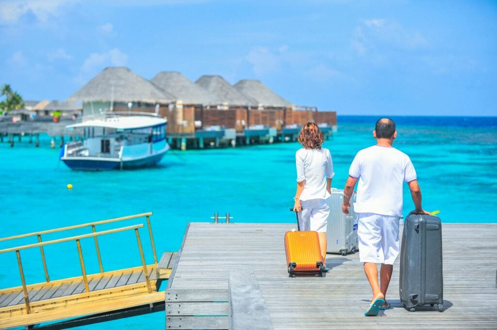 a couple walking towards their hut on a beach walk