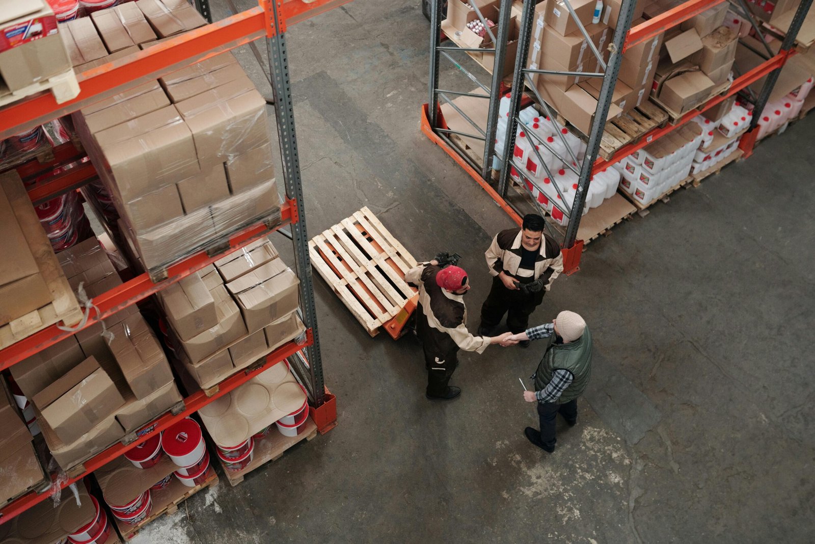 a warehouse staff and an owner shaking hands
