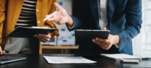 SME owner reviewing equipment investment options while considering asset finance instead of using cash reserves